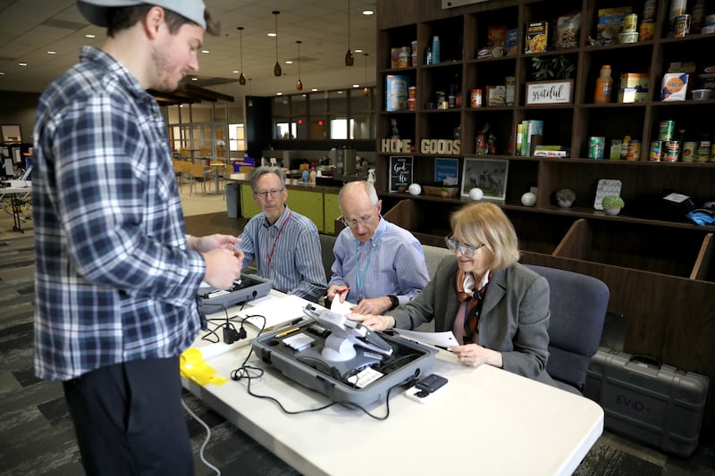 Matthew Wilcox of Geneva is assisted by election judges (from left) Larry Cabeen, Rudi Hebling and Pam Cabeen before voting in the 2025 Consolidated Election on Tuesday, April 1, 2025 at Chapelstreet Church in Geneva.