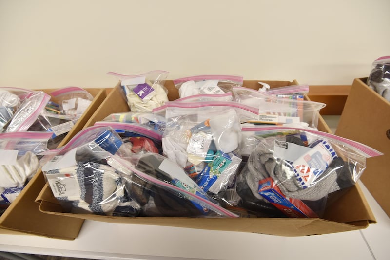 Dozens of “Helping Hands Care Kit” fill boxes at a MLK Day of Service event at the Elmhurst Public Library on Monday morning. The kits contained socks and toiletries and other items and will be donated to the Elmhurst Walk-In Assistance Network.