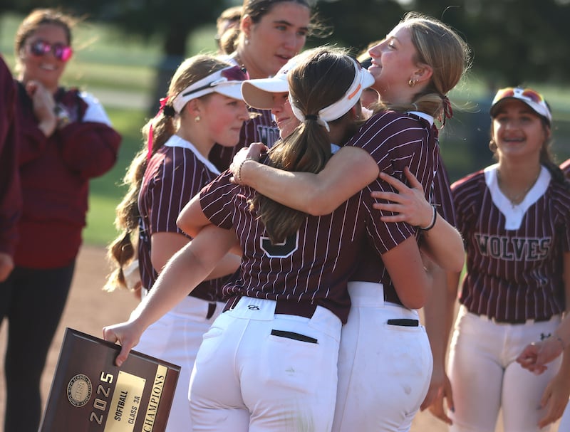 Prairie Ridge’s senior players Ady Kiddy, Kendra Carroll and Autumn Ledgerwood embrace after a win over Antioch in IHSA Class 3A Supersectional softball action at Kaneland High School in Maple Park on Monday, June 9, 2025.