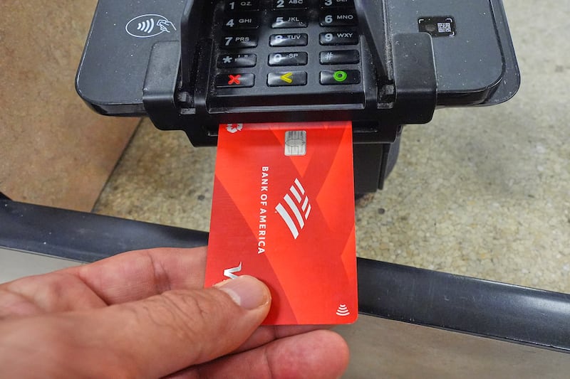 A credit card is used to complete a purchase at a grocery store in Dallas, Wednesday, April 15, 2026. (AP Photo/LM Otero)