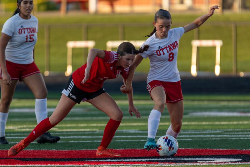 Georgia Kirkpatrick (8) of Ottawa pushes away Emersyn Hutchison (2) Of Metamora whilst dribbling ball on Tuesday, May 21, 2025 at Malone Field in Metamora.