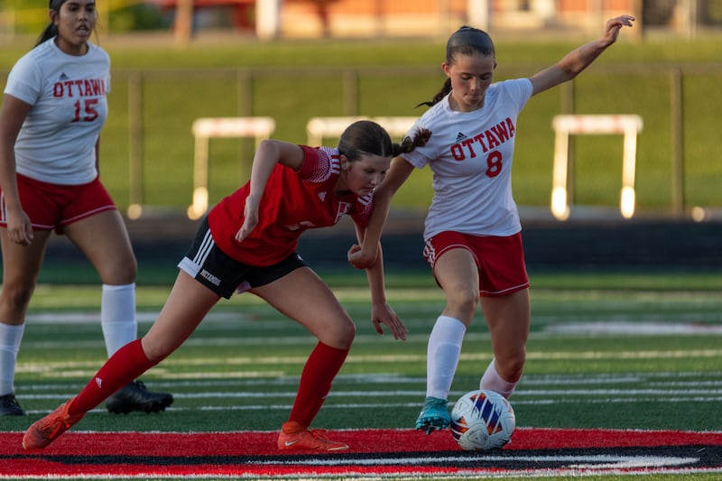 Georgia Kirkpatrick (8) of Ottawa pushes away Emersyn Hutchison (2) Of Metamora whilst dribbling ball on Tuesday, May 21, 2025 at Malone Field in Metamora.