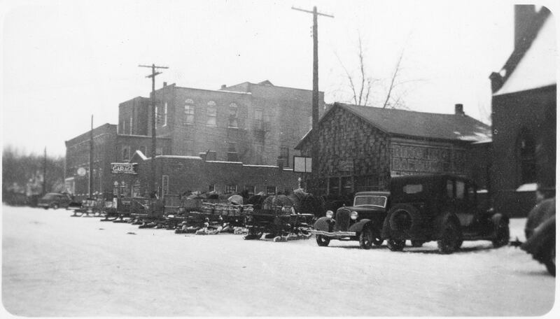 A mixture of horses and cars parked on Maple Street looking northeast in Sycamore, during a February 1936 cold snap.