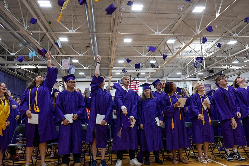 Hats go airborne as the Dixon High School class of 2024 is announced as graduates Sunday, May 26, 2024.