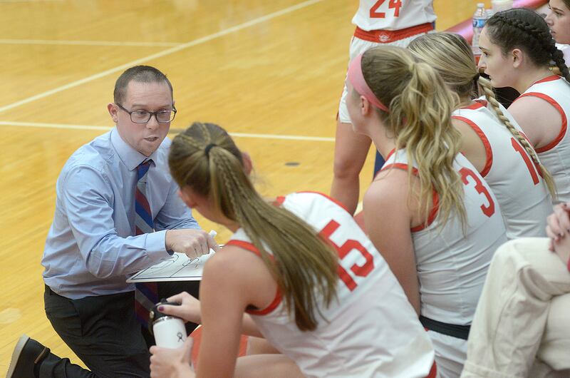 Ottawa Lady Pirates Head Coach Brent Moore goes over stodgy during a times out against Kaneland in the 3rd period Friday at Ottawa.