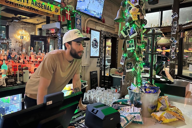 Evan Duke, a 30-year-old bartender who lives in Raleigh, N.C., works at the Pearl & Peril, March 10, 2026, in the city's Glenwood South bar district. (AP Photo/Bill Barrow)