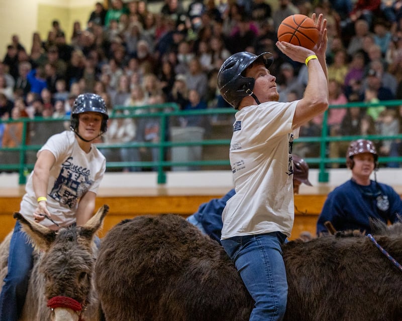 Member of 'Seneca FFA Officers and Alumni' shoots ball in game of Donkey Basketball on Saturday, Feb. 7, 2026 at Seneca High School West Campus in Seneca.