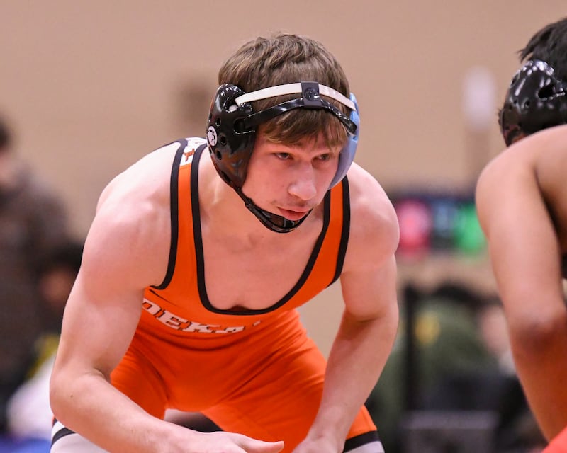 DeKalb’s wrestler Ayden Shuey keeps his focus while taking on Danny Delgado of Glenbard East on Tuesday Dec. 30, 2025, in the 132-weight class during the Flavin Invite held in DeKalb High School.