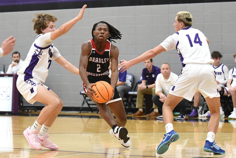 Bradley-Bourbonnais' Kobe Lawrence, center, drives to the basket between Manteno's Jack Gotkowski, left, and Dylan Polito during a game at Manteno Saturday, Dec. 6, 2025.