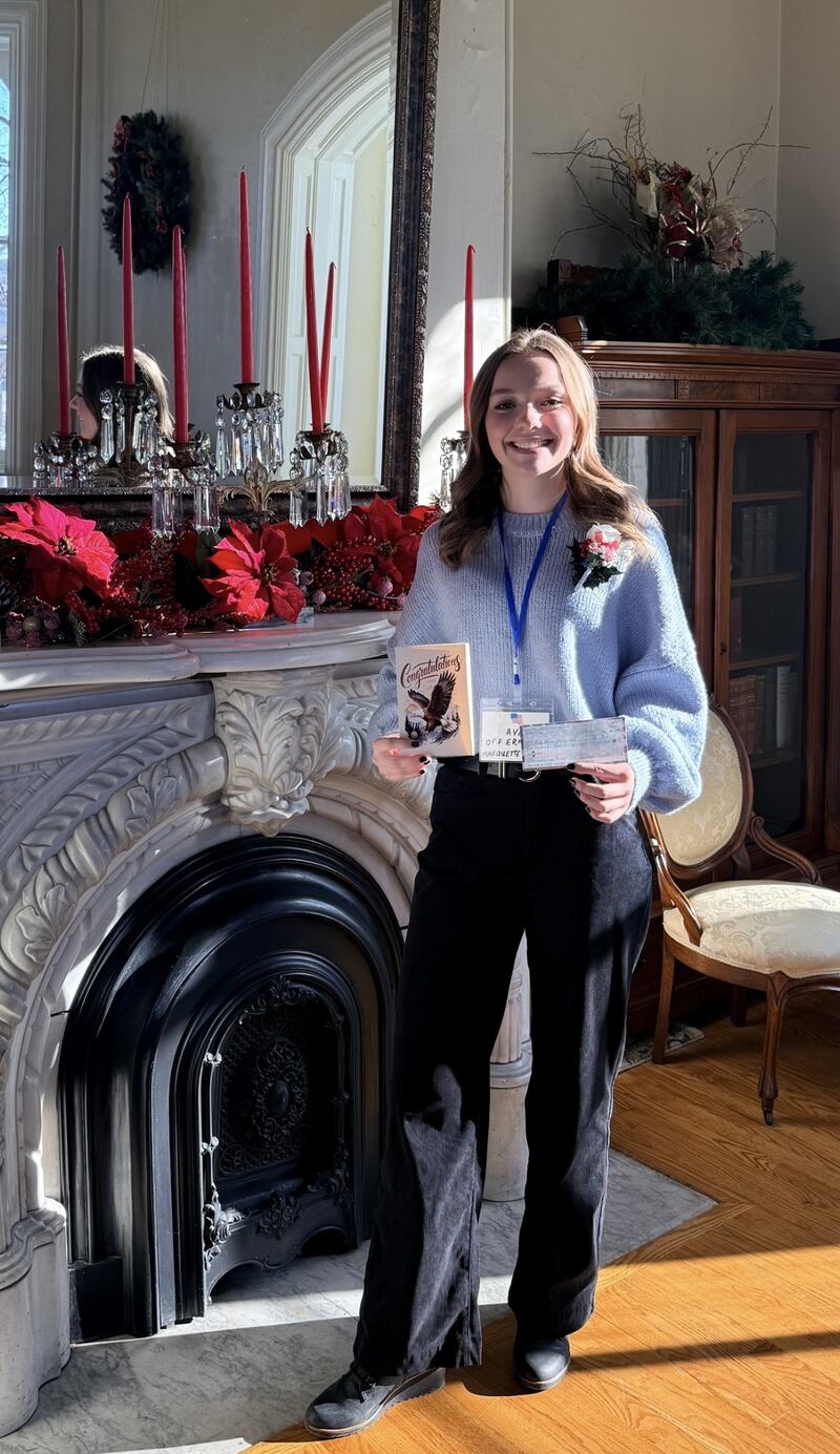 Ava Offermann of Marquette Academy receives the DAR Illini Chapter scholarship Dec. 4 at the Reddick Mansion in Ottawa.