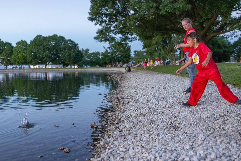 Frankie Bianco skips takes a few pointers on how to skip stones prior to the start of the fireworks on June 28, 2025 at Lake Mendota.