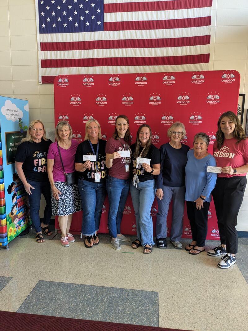 OCUSD first-grade teachers receive checks from the Mt. Morris Community Library Foundation to buy books for first-grade students this year. Left to right: Teacher Dawn Merrill, Foundation member Sandra Stengel, teachers Gretchen Nelson, Erica Cann, Kenzie Dusing, Foundation members Mary Jane Warkins and Paula Diehl, and teacher Olivia Phalen.