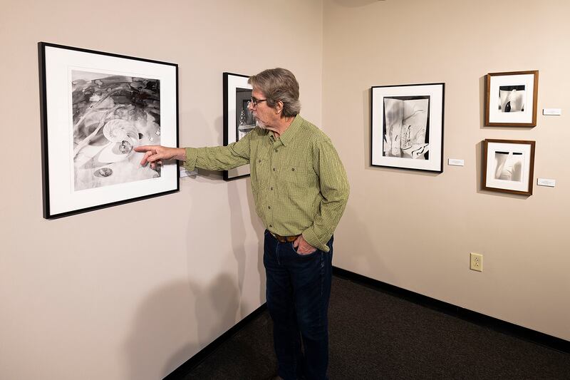 Photographic artist Les Allen points out objects in one of his works on display Tuesday, Oct. 7, 2025. The show will be up until Nov. 20 in the second-floor, east-end art gallery at Sauk Valley Community College in Dixon.