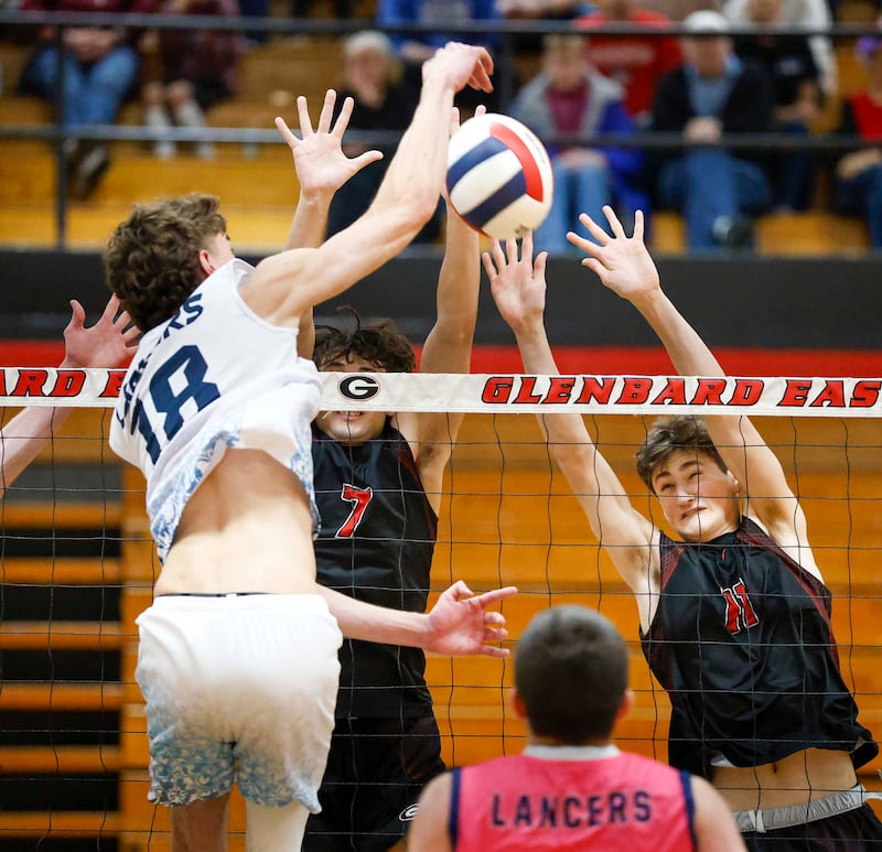 Lake Park’s Nolan Cocat, (18) tries to split Glenbard East’s Jackson Yates (7) and Max Waldschmidt, (11) during the semifinals of the Glenbard East boys volleyball tournament Saturday, April 11, 2026 in Lombard.