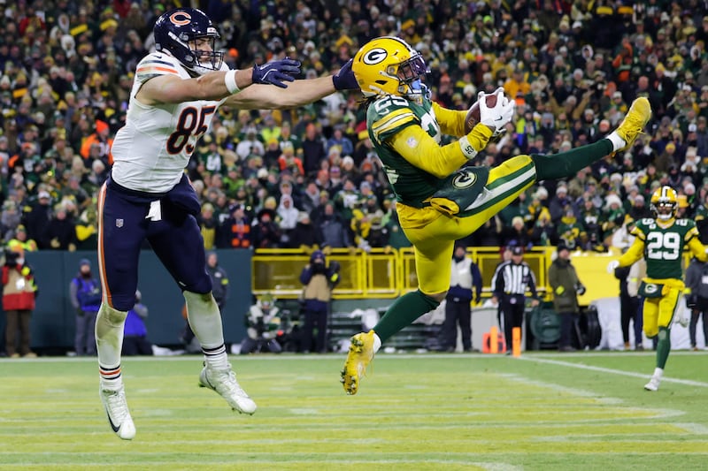 Green Bay Packers cornerback Keisean Nixon (25) intercepts a pass against Chicago Bears tight end Cole Kmet (85) during the second half of an NFL football game Sunday, Dec. 7, 2025, in Green Bay, Wis. (AP Photo/Matt Ludtke)