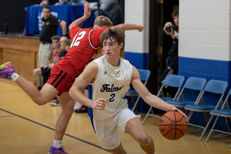 Faith Christian’s Carson Bivins handles the ball against QC Christian Tuesday, Dec. 9, 2025.