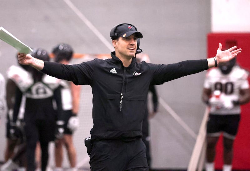 New Northern Illinois defensive coordinator Rob Harley talks to his players during the first spring football practice Thursday, March 27, 2025, in the Chessick Practice Center at NIU in DeKalb.
