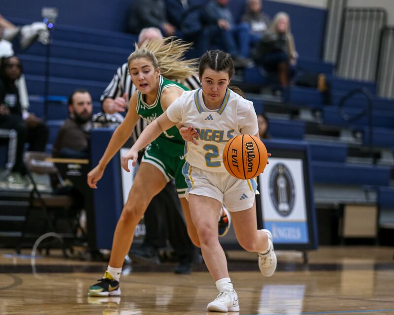 Joliet Catholic's Madeline Moran (2) drives past the defense during their basketball game between Providence Catholic at Joliet Catholic. Feb 11, 2025 in Joliet.