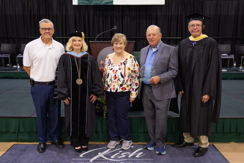 (From left) Frank Roberts, Kishwaukee College President Laurie Borowicz, award recipients T.J. Irving and Steve Irving and Board Chair Bob Johnson pose for a photo after the Irvings were bestowed the 2026 John C. Roberts Award on May 16, 2026, during spring Commencement.