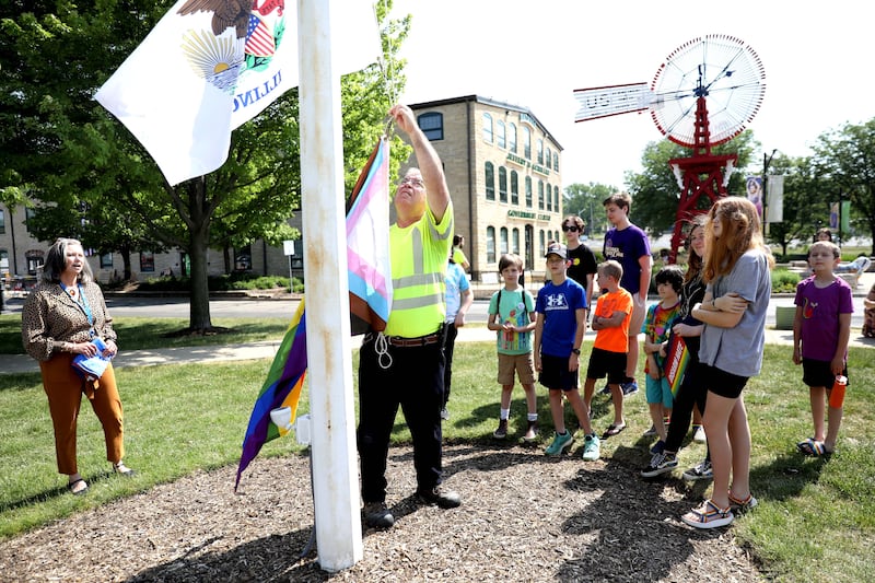 George Ingersoll of the Batavia Public Works Department assists raising of the Pride flag in honor of Pride Month in Batavia on Thursday, June 1, 2023.