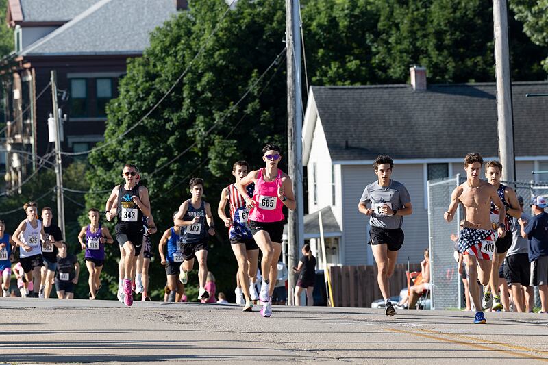Runners head south on Hennepin Avenue on Saturday, July 6, 2024 at the start of the Reagan Run 5K in Dixon.