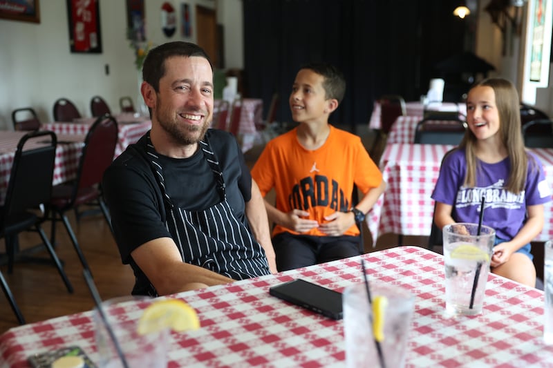 Chef owner Nick Bohn, left, smiles alongside his children, Kooper, 12, left, and Kinnley, 11, during an interview at the Longbranch restaurant in L'Erable on Wednesday, June 10, 2026, ahead of his life-saving kidney transplant on June 24.