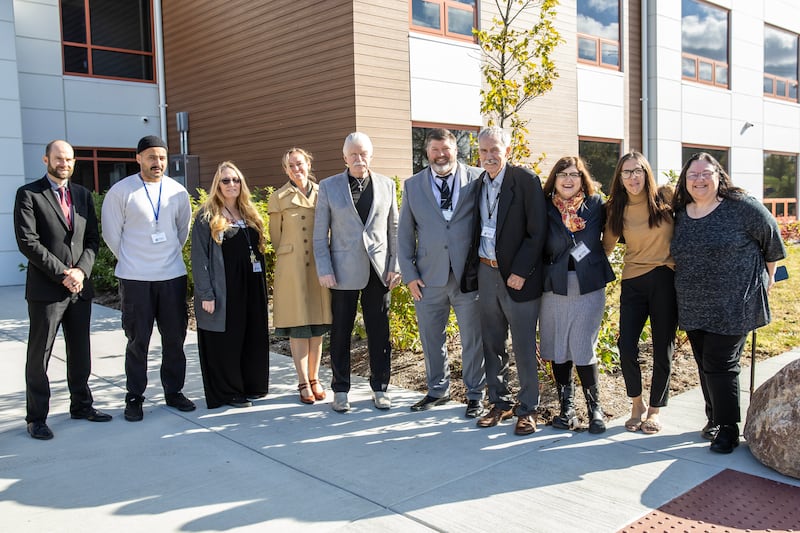 Stepping Stones staff members, supporters, and elected officials take a photo outside the organization’s new Women and Children Recovery Home on Oct. 30, 2025.