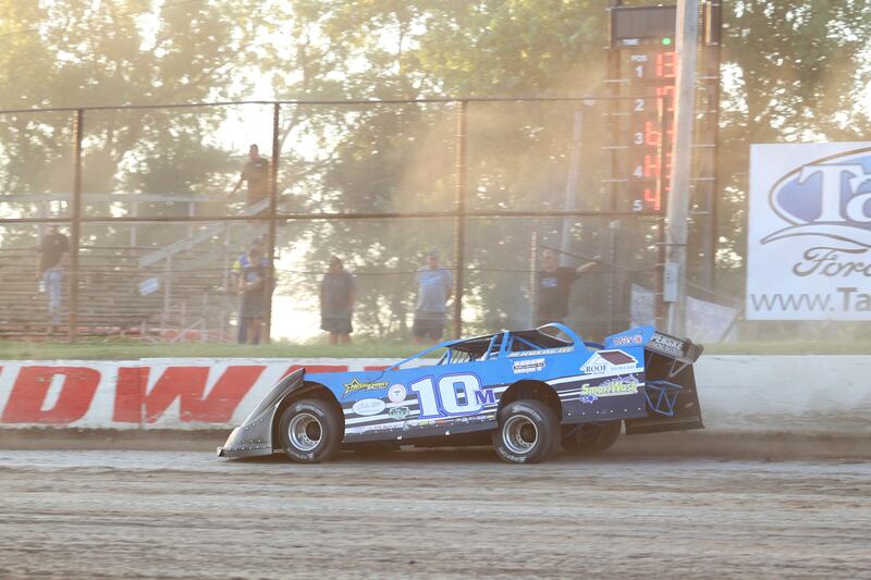 Austin McCarty accelerates during a heat race past members of his family on Friday, July 4, 2025, at the Kankakee County Speedway. McCarty picked up a win in the pro late model feature, his fourth in a row, in what was an emotional day at the track for the McCarty family.