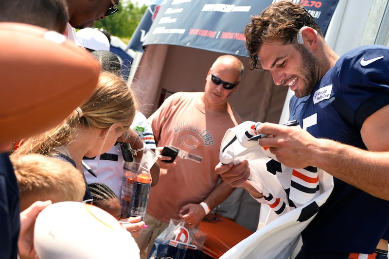 Chicago Bears tight end Cole Kmet signs autographs for fans after an NFL football training camp practice in Lake Forest, Ill., Saturday, July 27, 2024. (AP Photo/Nam Y. Huh)