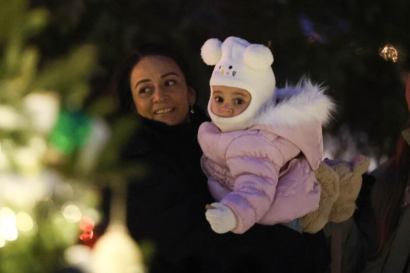 A mother and her child admire the Christmas trees at Plainfield’s holiday kickoff Grinchmas on the Green on Saturday, Dec. 5, 2025 in Plainfield.