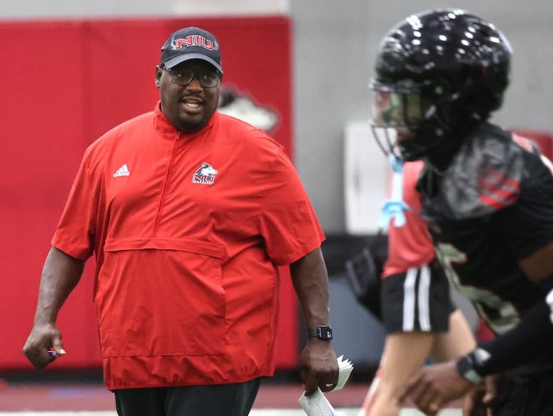 Northern Illinois’ head coach Thomas Hammock talks to a player Wednesday, July 30, 2025, at the teams first practice of the season in the Chessick Practice Center at NIU in DeKalb.