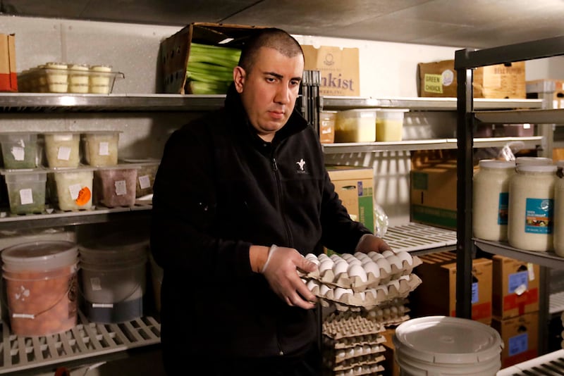 Angelo Angelos carries a container of eggs out of the cooler on Friday, March 21, 2025, at Andy's Restaurant, in Crystal Lake.