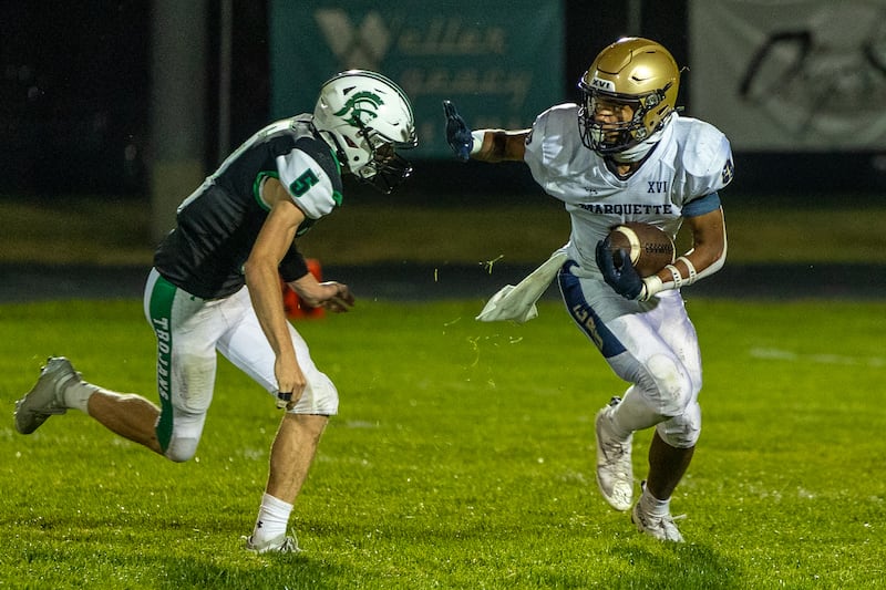 Connor Baker (6) of Marquette pushes off Joe Duffy (5) of Dwight while running the ball Friday, Sept. 19, 2025, in Dwight.