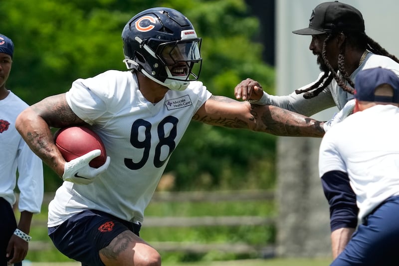 Chicago Bears defensive end Montez Sweat, left, works with defensive backs/passing game coordinator Al Harris during the NFL football team's practice in Lake Forest, Ill., Wednesday, June 10, 2026. (AP Photo/Nam Y. Huh)