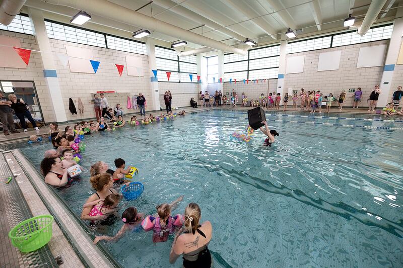 Louise Whyte dumps the first load of eggs in the pool at the Sterling-Rock Falls YMCA Friday, April 11, 2025.