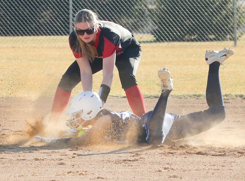 Bureau Valley's Danicka Benavidez slides safe into second base as Hall's Caroline Morris drops the ball on Monday, March 9, 2026 at Bureau Valley High School.