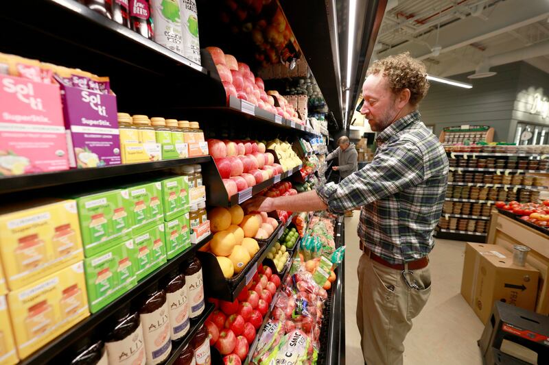 General Manager Gabriel Smith looks over the produce at Prairie Food Co-op Tuesday, July 8, 2025 at Eastgate Shopping Center, in Lombard as they prepare for Wednesday's ribbon-cutting and soft opening marks a 13-year journey toward creating this store.