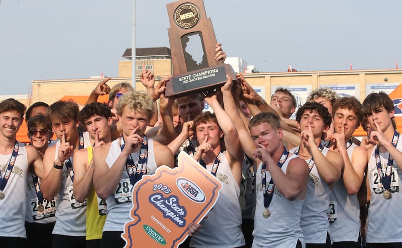 Members of the Sycamore boys track team hoist the Class 2A first place trophy during the IHSA Class 1A Boys Track & Field State Finals on Saturday, May 31, 2025 at Eastern Illinois University in Charleston.