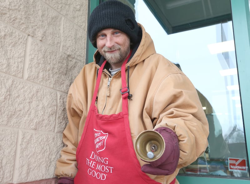 Jacob Robinson a bell ringer with The Salvation Army, stands in front of Handy Foods on Thursday, Dec. 12, 2024 in Ottawa. Robinson has been volunteering with the Salvation Army for six years.