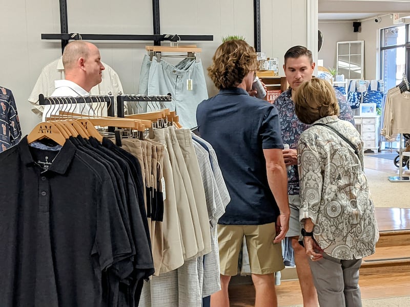 American-Male co-owner Mike Plachetka, right, talks to customers following a ribbon-cutting ceremony on June 20.