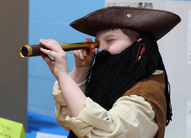 Third grader Carter Sheelor, playing Captain Blackbeard, waits for someone to press the button to activate his speech during the Hinckley Big Rock Elementary School Wax Museum Thursday, March 13, 2025, at the school in Hinckley.