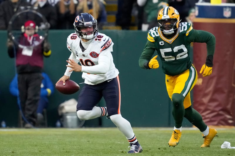 Chicago Bears quarterback Caleb Williams (18) looks to pass against Green Bay Packers defensive end Rashan Gary (52) during the first half of an NFL football game, Sunday, Dec. 7, 2025, in Green Bay, Wis. (AP Photo/Morry Gash)
