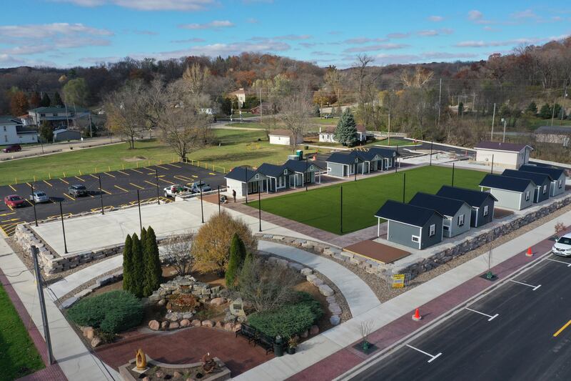 Want to do some holiday shopping at Utica's forthcoming outdoor retail plaza? Mayor David Stewart said he hopes the project will be completed in early to mid December, leaving shoppers a few weeks to buy presents for their families. Crews from the Utica Public Works department are building wooden decking on the corners of the site next to the huts at the Market on Mill, seen here in an aerial photo Tuesday, Nov. 12, 2024.