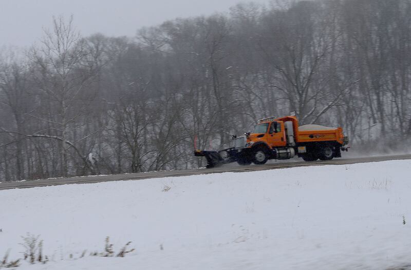 A snow plow sprays salt along Interstate 180 on Monday, Dec. 1, 2025 near Hennepin.