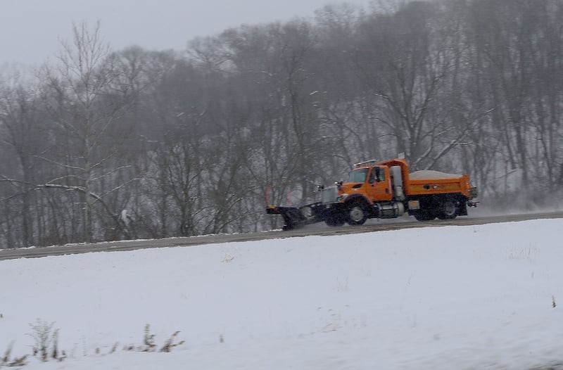 A snow plow sprays salt along Interstate 180 on Monday, Dec. 1, 2025 near Hennepin.