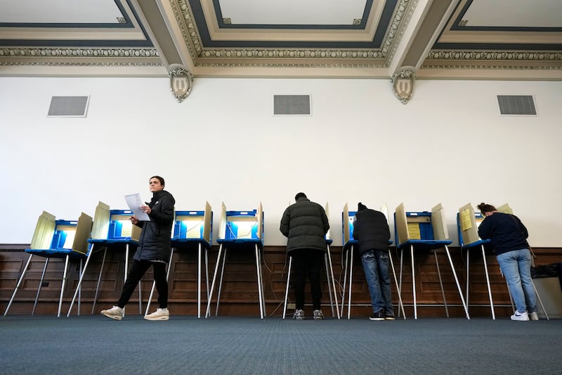 Voters mark their ballots while voting at Centennial Hall at the Milwaukee Central Library on Election Day Tuesday, April 1, 2025, in Milwaukee. (AP Photo/Kayla Wolf)