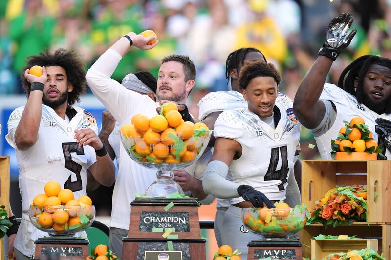 Oregon head coach Dan Lanning, second left, celebrates with quarterback Dante Moore (5), defensive back Brandon Finney Jr. (4), and defensive lineman Bear Alexander after defeating Texas Tech in the Orange Bowl College Football Playoff quarterfinal game, Thursday, Jan. 1, 2026, in Miami Gardens, Fla. (AP Photo/Rebecca Blackwell)