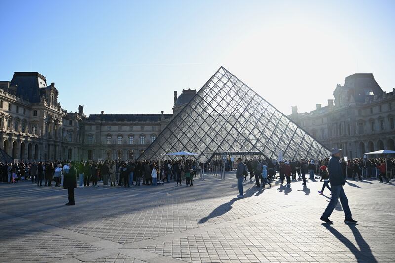 People queue to enter the Louvre museum, Thursday, Oct. 30, 2025 in Paris. (AP Photo/Emma Da Silva)