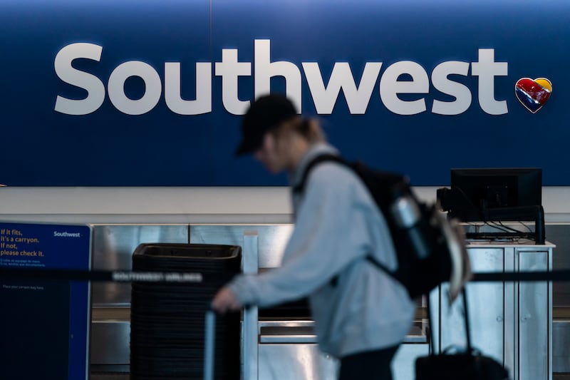 FILE - A traveler walks through the Southwest Airlines ticketing counter area at the Los Angeles International Airport in Los Angeles, April 18, 2023. (AP Photo/Jae C. Hong, File)