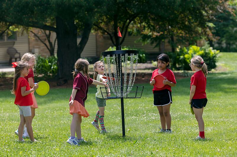 After ice cream, students grab the discs and play some golf Wednesday, May 29, 2024, at St. Anne’s School in Dixon.